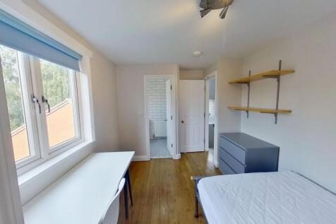 Bright, neatly presented bedroom with a large w...