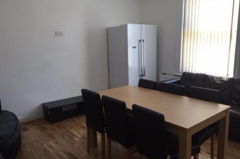 Bright furnished living area with a dining tabl...