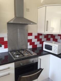 Compact modern kitchen with stainless-steel ove...