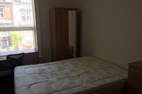 Bright double bedroom with a large window, doub...
