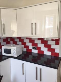 Bright modern kitchen corner with glossy white ...