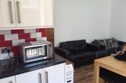 Bright compact kitchen area with modern white c...