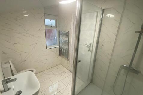 Bright modern bathroom with elegant marble-effe...