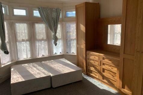 Bright and spacious double bedroom featuring la...