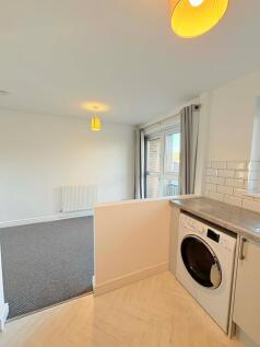 Bright open-plan living area with a neutral déc...