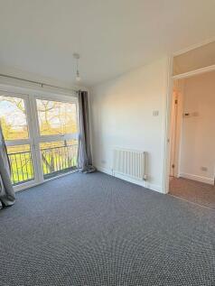 Bright bedroom with large floor-to-ceiling wind...