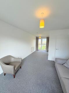 Bright, modern living room with neutral décor, ...