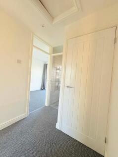 Bright, freshly decorated hallway with neutral ...