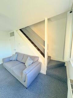 Bright, freshly-decorated living area with a co...