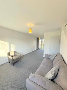 Bright, modern living room with neutral décor, ...