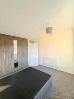 Bright, neatly presented bedroom with built-in ...