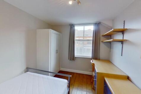 Bright, tidy bedroom with wooden floors, a ward...
