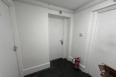 Well-maintained internal hallway with clean whi...