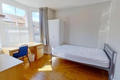 Bright, neatly presented bedroom with a large b...