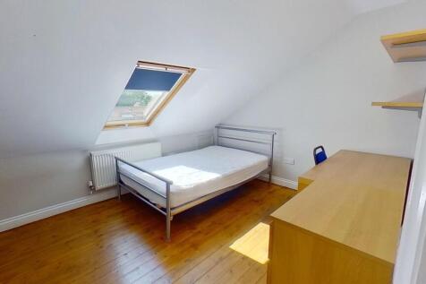 Bright, neatly presented bedroom in an attic-st...
