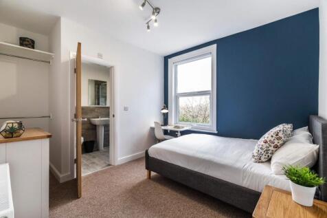 Bright, neatly presented bedroom with a comfort...