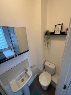 Neat, modern bathroom with a compact sink, mirr...
