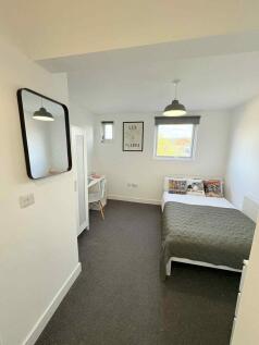 Bright, neatly presented bedroom with a comfort...