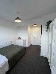 Bright, modern double bedroom with neutral deco...