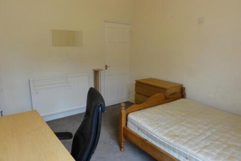 A cozy student single bedroom featuring a woode...