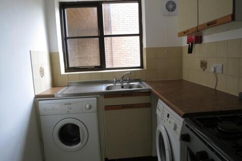 A functional kitchenette with ample counter spa...