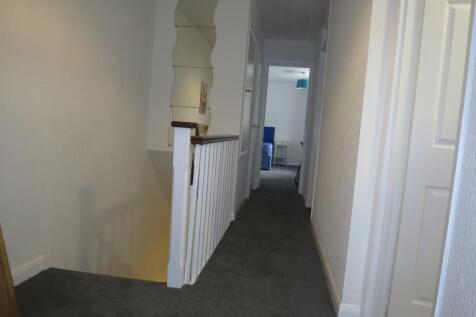 A well-maintained and tidy hallway, offering a ...