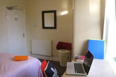 Bright single bedroom with a study desk by the ...