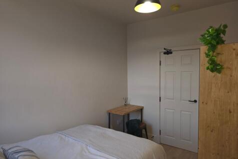 Bright, neatly presented bedroom with a made do...