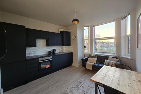 Bright open-plan living area with a modern fitt...