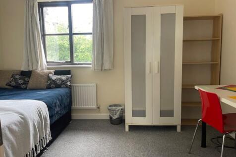 A bright and inviting double bedroom with ample...