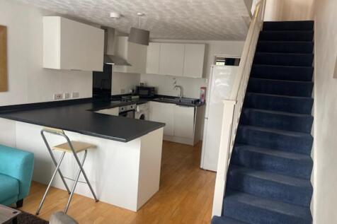 A bright and modern kitchenette with ample spac...