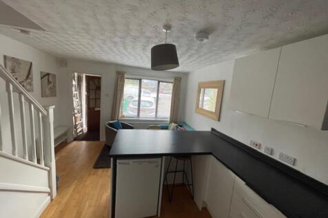 A bright and inviting kitchenette with modern f...