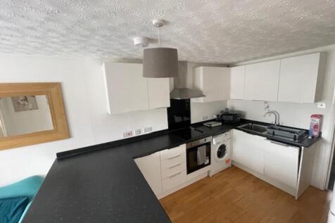 A modern and tidy kitchenette featuring ample s...