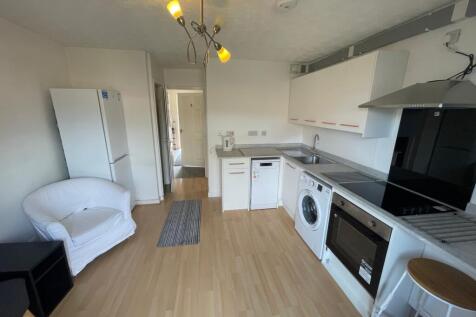 A modern and tidy kitchenette equipped with ess...