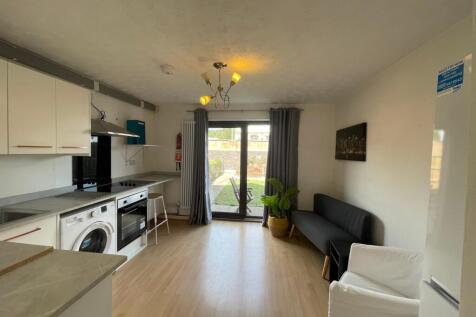 A bright and modern kitchenette with ample spac...