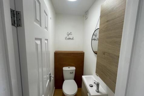 A modern and tidy single toilet with stylish de...