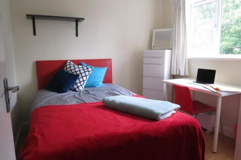 A bright and cozy double bedroom featuring a co...