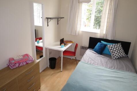 A bright and tidy double bedroom featuring a co...
