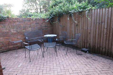 A lovely garden area with a cozy seating arrang...
