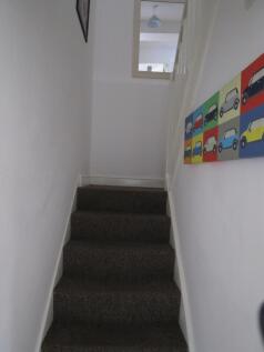 A tidy staircase leading to the upper levels, w...