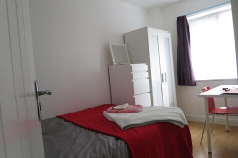 Bright, simply furnished single bedroom with a ...