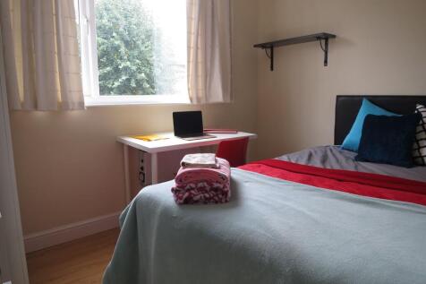 Bright, neatly presented bedroom with a comfort...