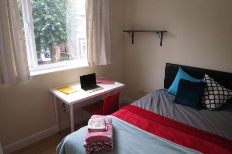 Bright, neatly presented bedroom with a comfort...