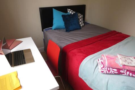 Neat single bedroom with a comfortable bed dres...