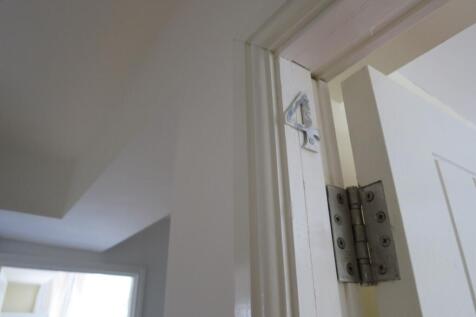 Close-up view of a white interior doorway and h...