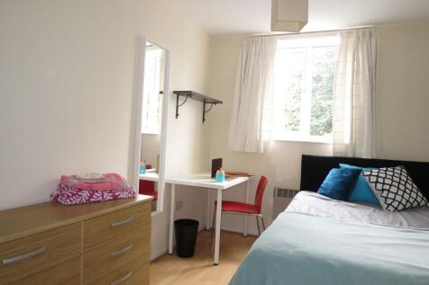 Bright, neatly presented bedroom with a comfort...