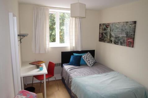 Bright, neatly presented bedroom with a comfort...