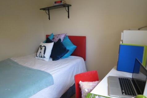 Bright, neatly presented bedroom with a comfort...