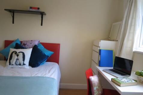 Bright, neatly presented bedroom with a comfort...