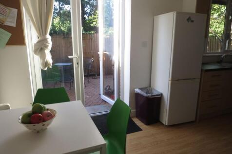 Bright kitchen/dining area with a white table, ...